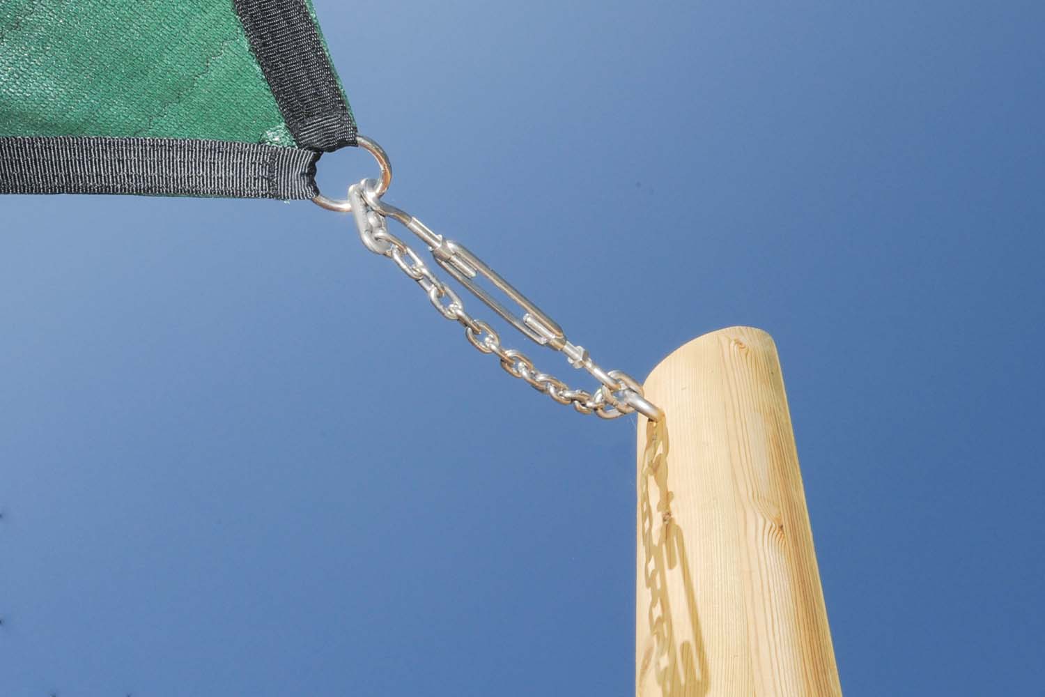 Close view of the corner of a shade sail fixed to a wooden post