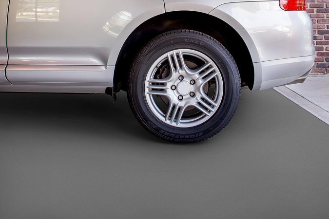 A car parked on a garage floor recently treated with the best garage floor coating option