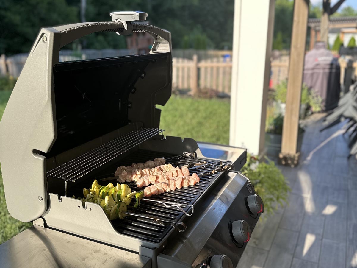 Meat and veggies cooking on the Weber Spirit II E-310 Gas Grill