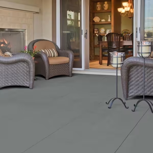 Concrete flooring on patio with outdoor furniture set on top; a sliding door in background.