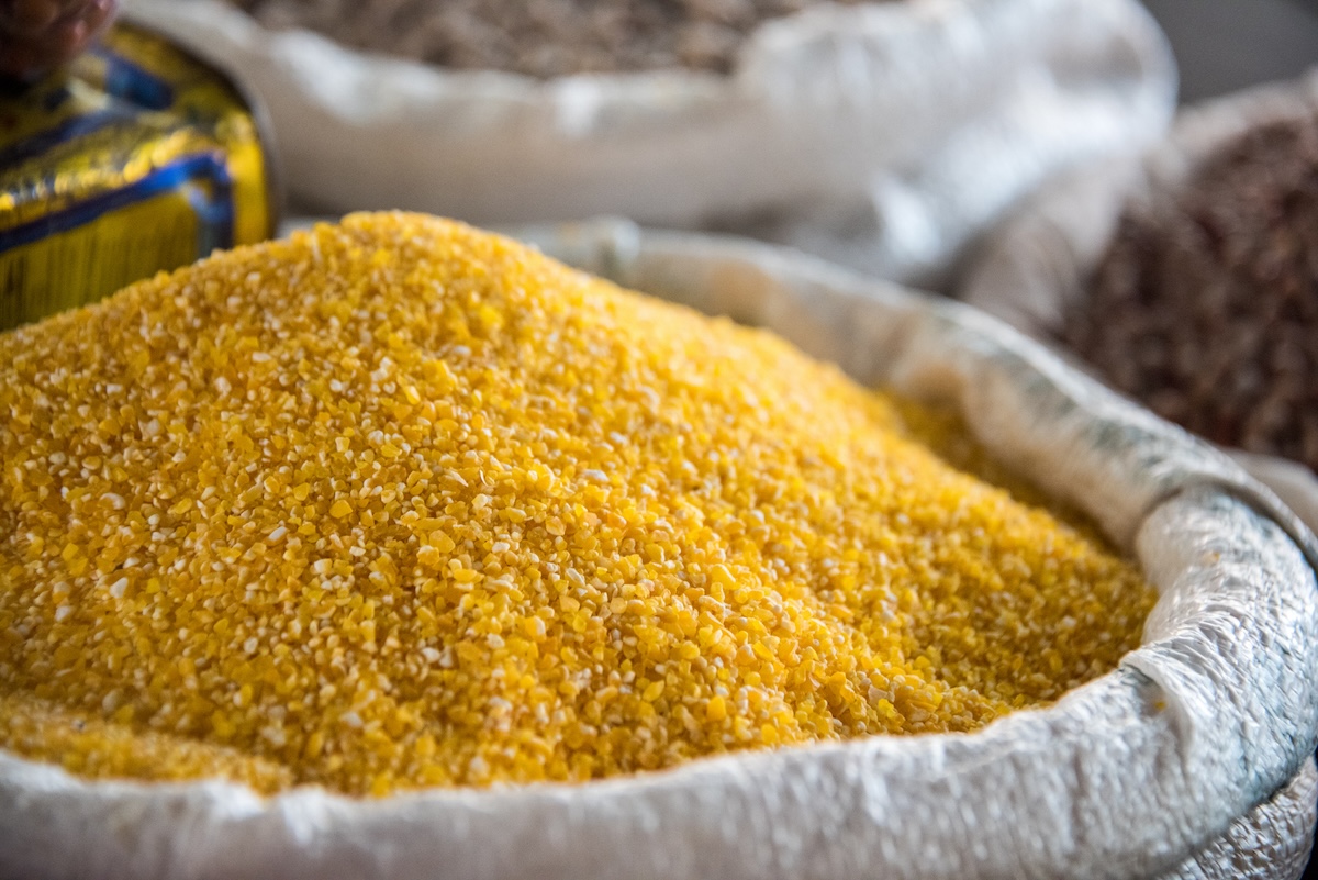 Corn gluten meal in a basket with a white cloth.