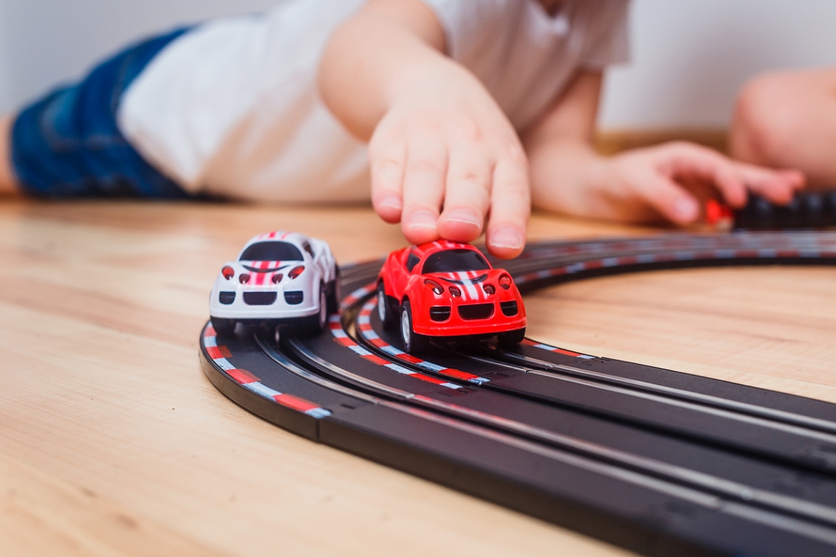 Child playing with toy cars