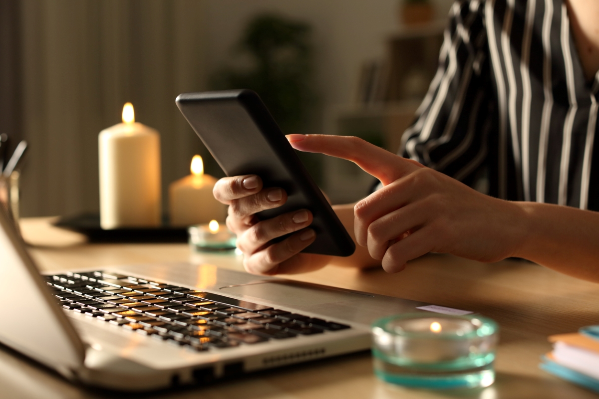 Woman dialing on phone in the dark