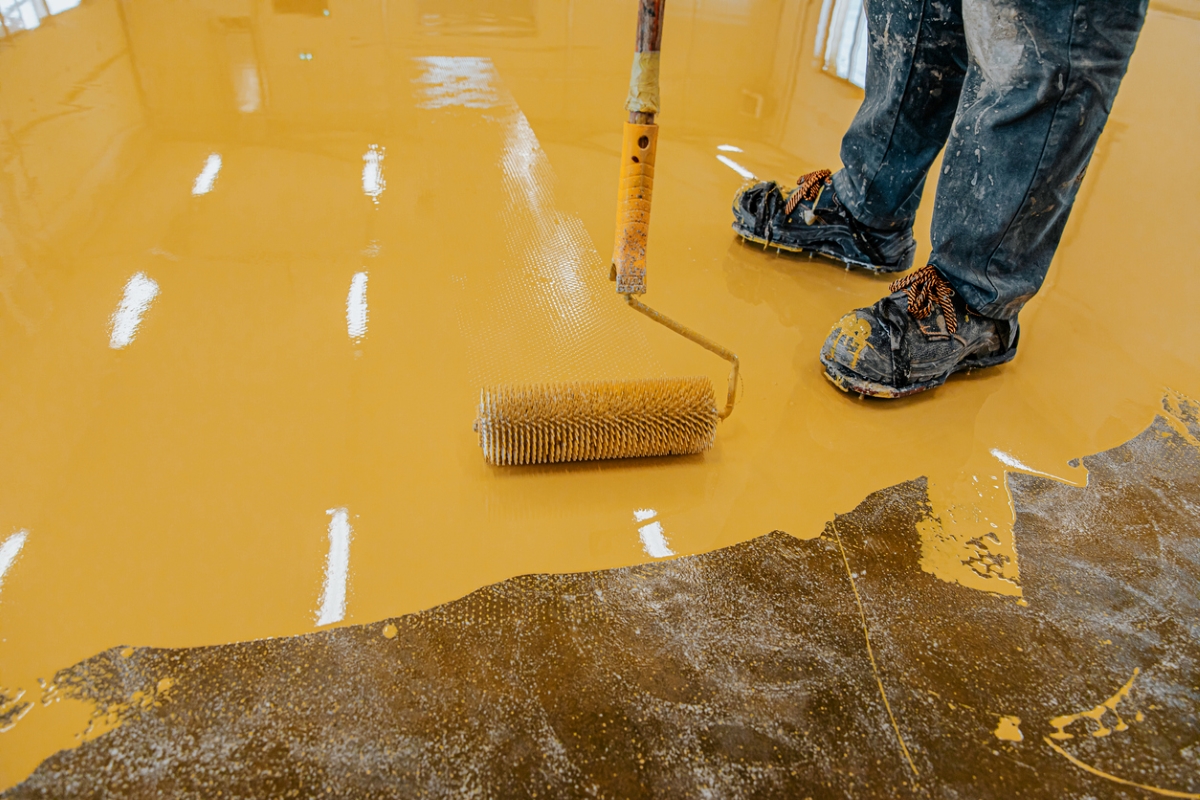 Person spreading orange epoxy