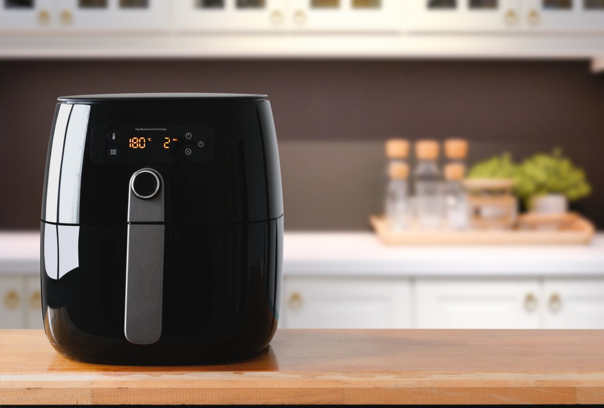 a black shiny air fryer on a kitchen counter