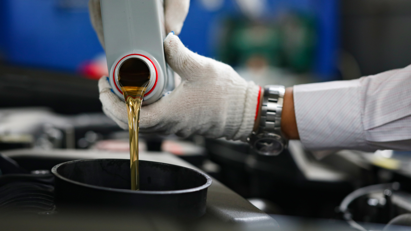 pouring fuel additive into gas container