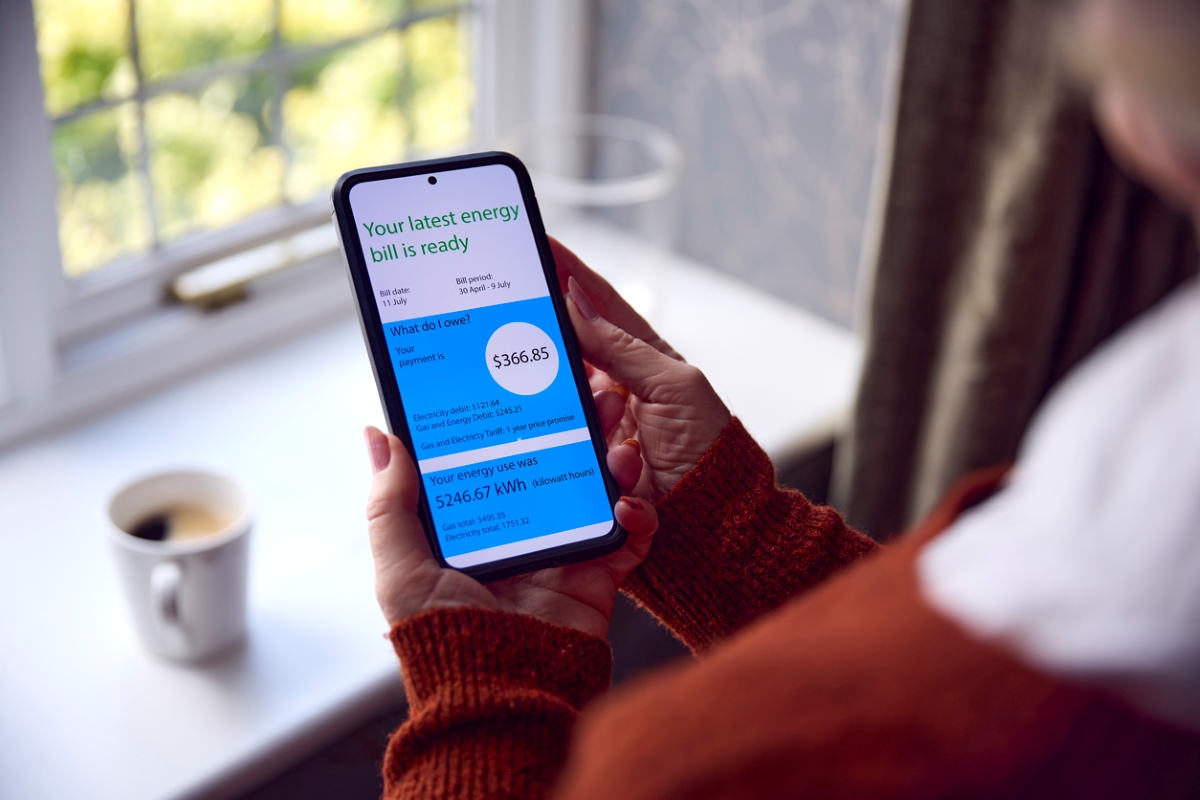 Woman looking at energy bill on phone