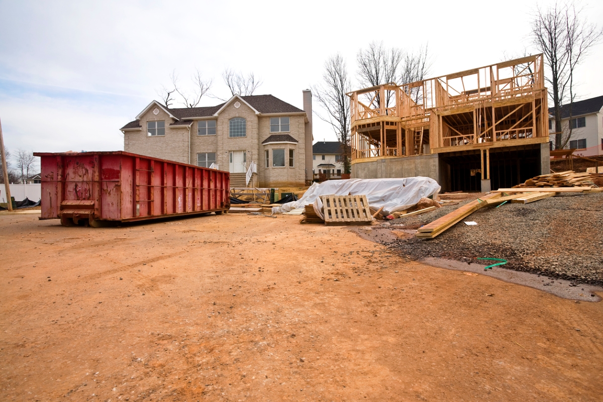 Construction dumpster in front of house