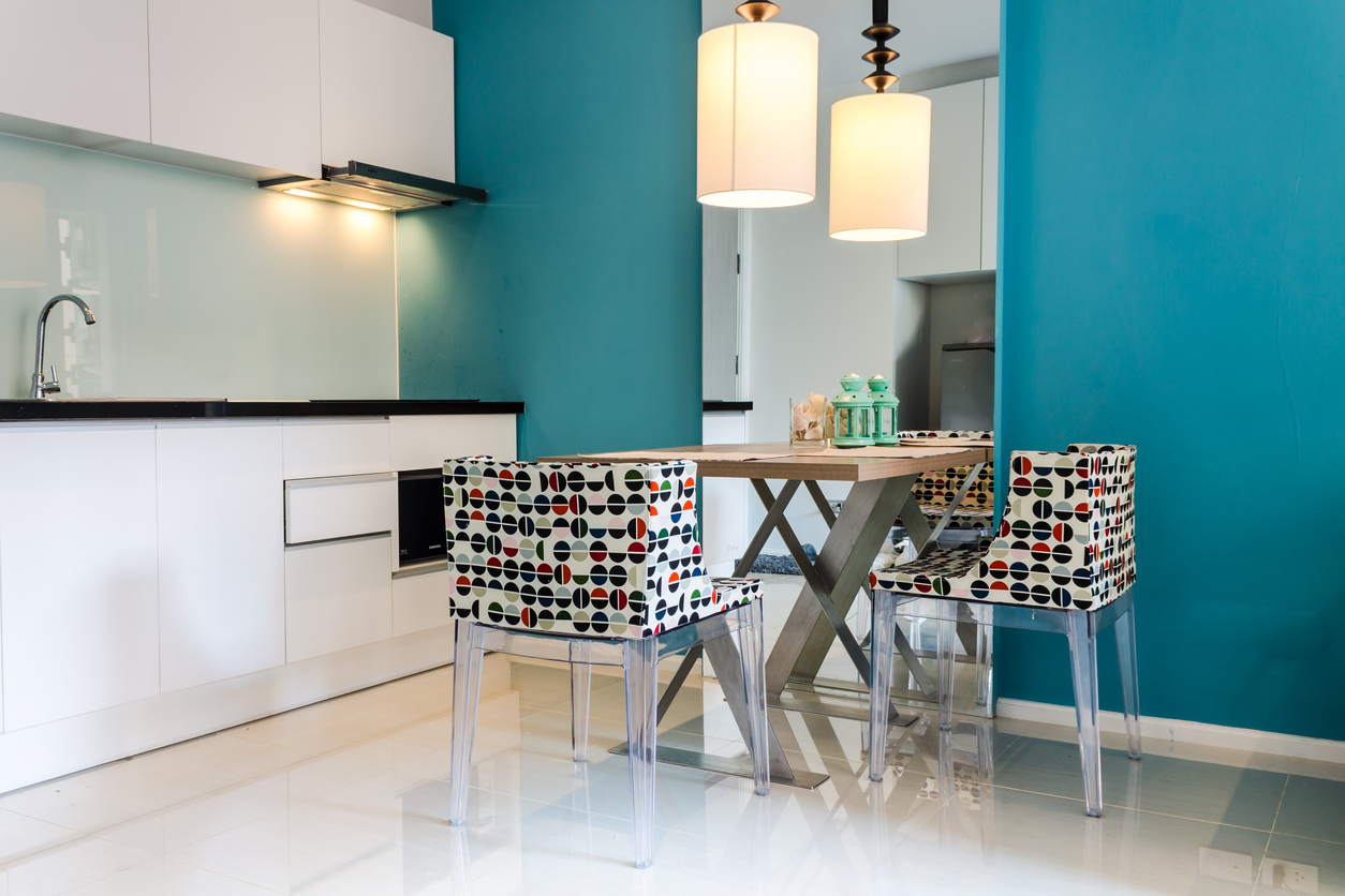 Blue accent wall in small white kitchen