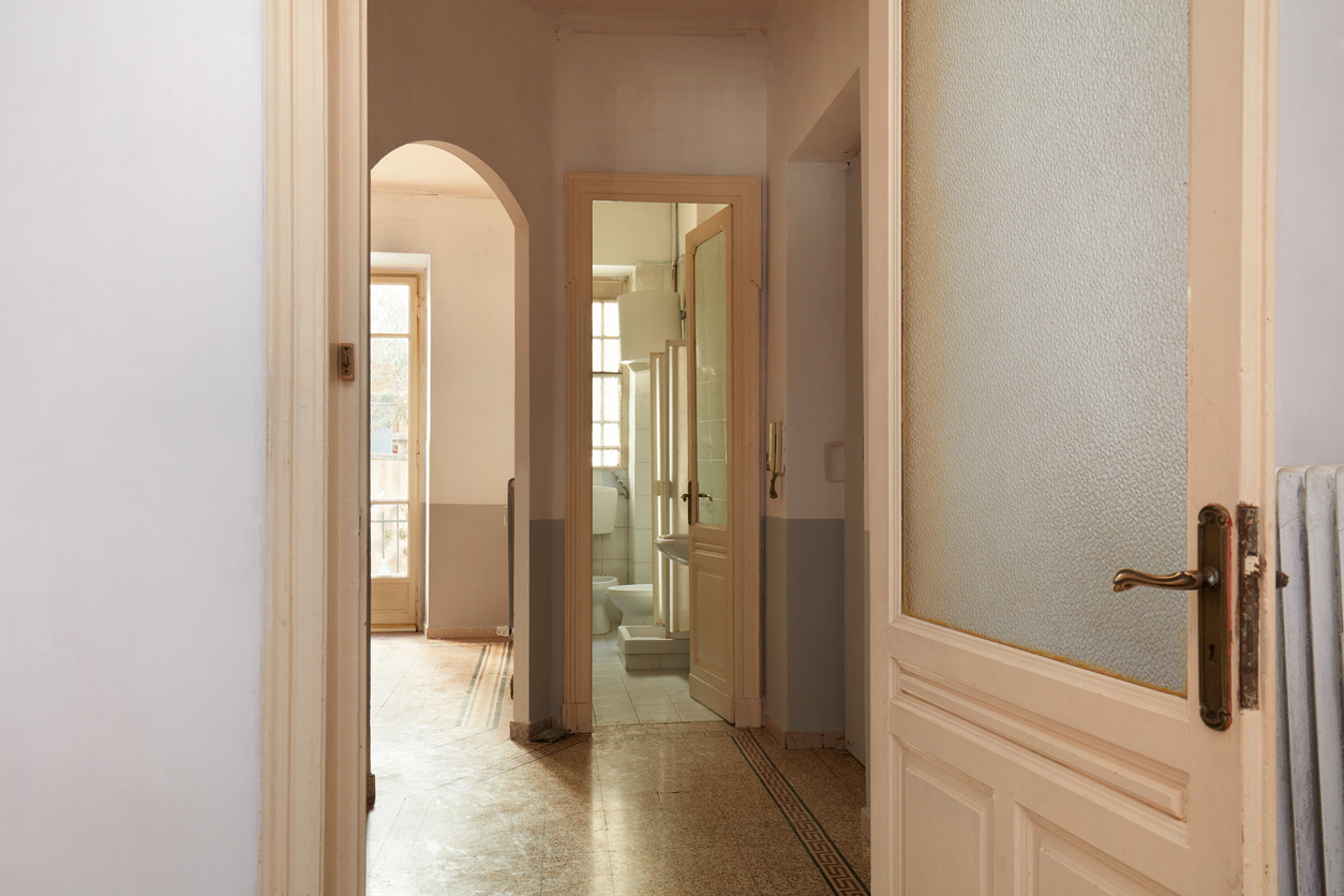 open door leading to hallway and other rooms in house