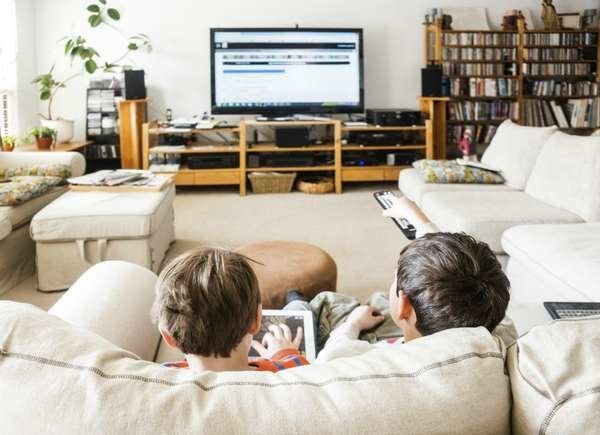 kids watching TV on a TV stand