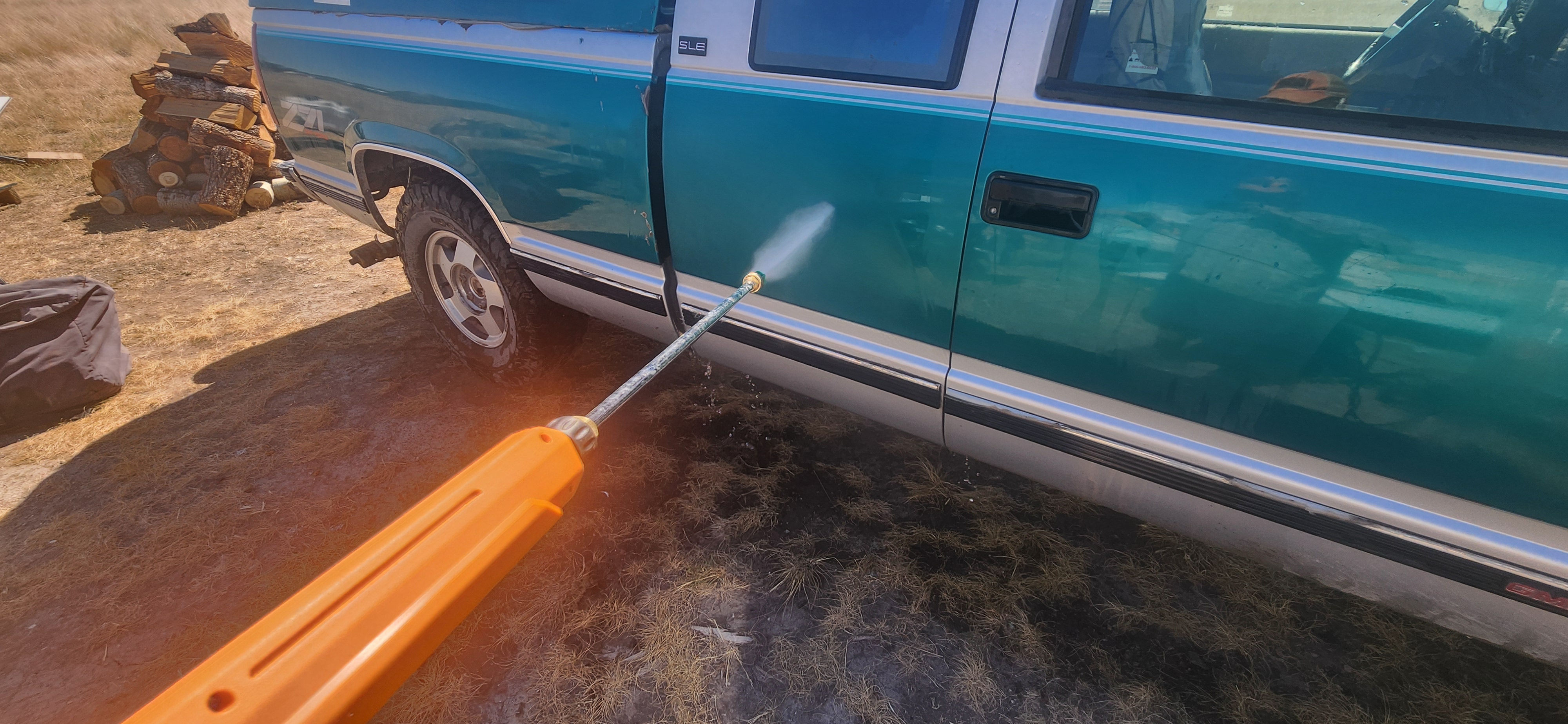 Truck being cleaned by gas pressure washer