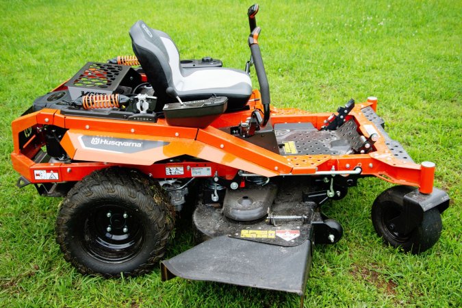 The Husqvarna XCite 350 zero turn riding mower sitting on a green lawn