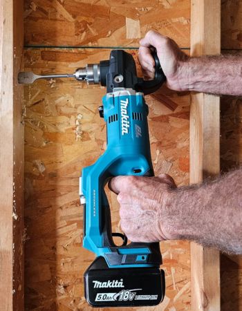 A person actively using the Makita right-angle drill