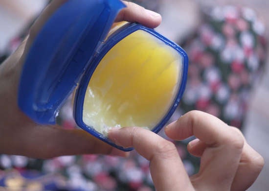 Overhead shot of person putting finger in vaseline