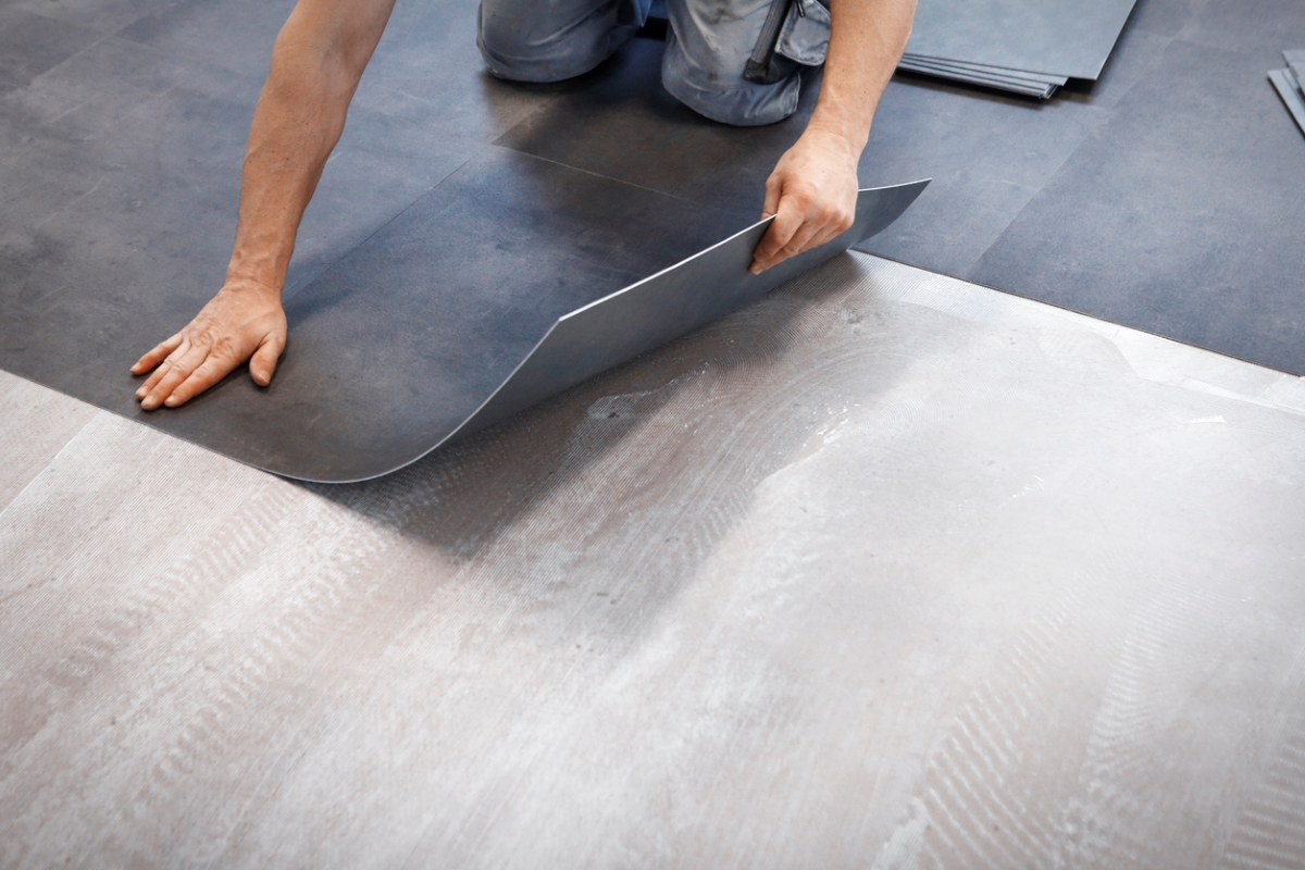 Worker installing vinyl tiles