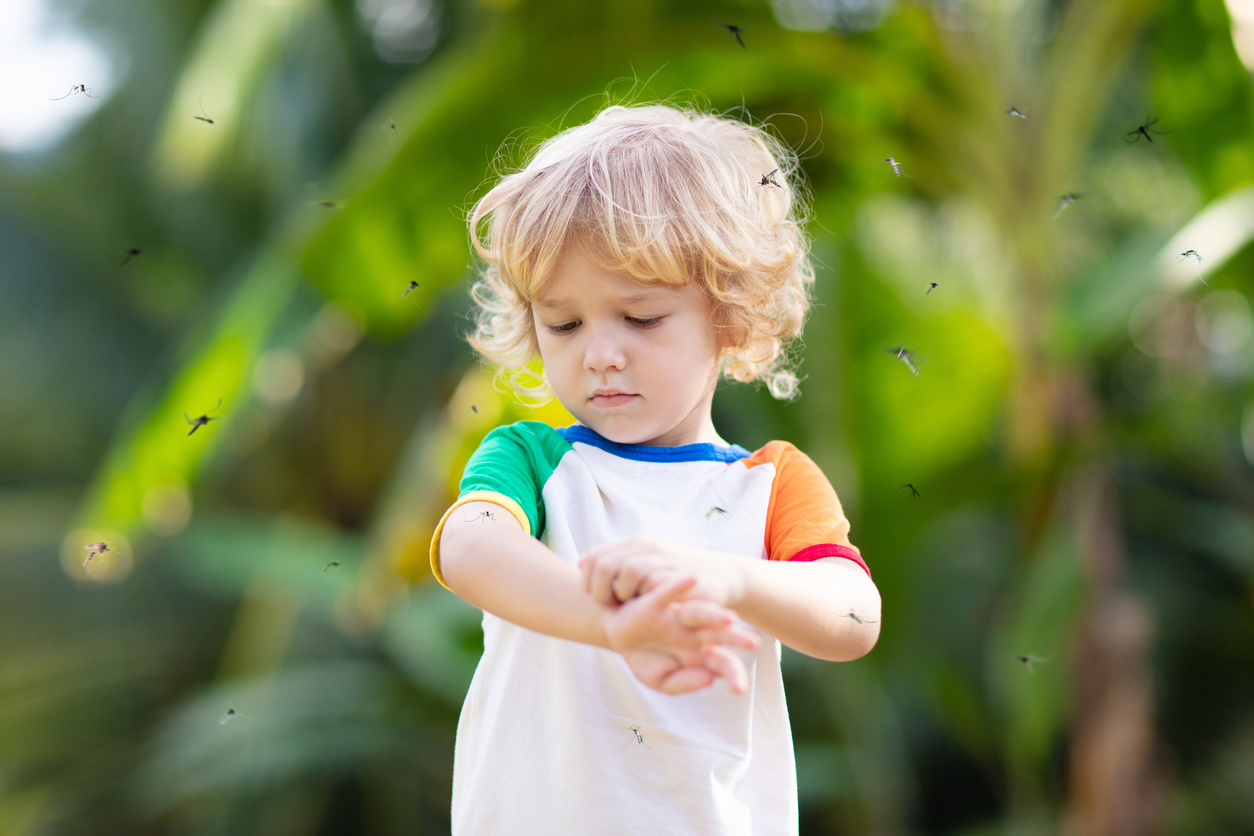 boy surrounded by mosquitos