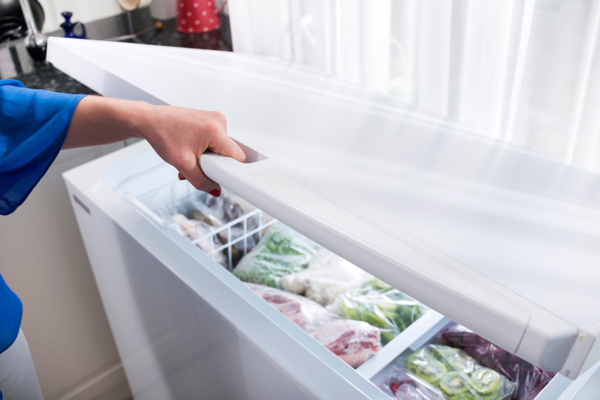 Woman hand opening a refrigerator door