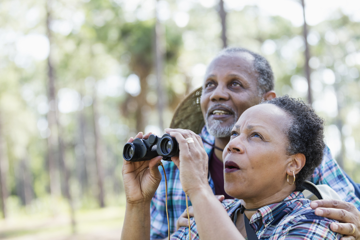 senior couple bird watching together