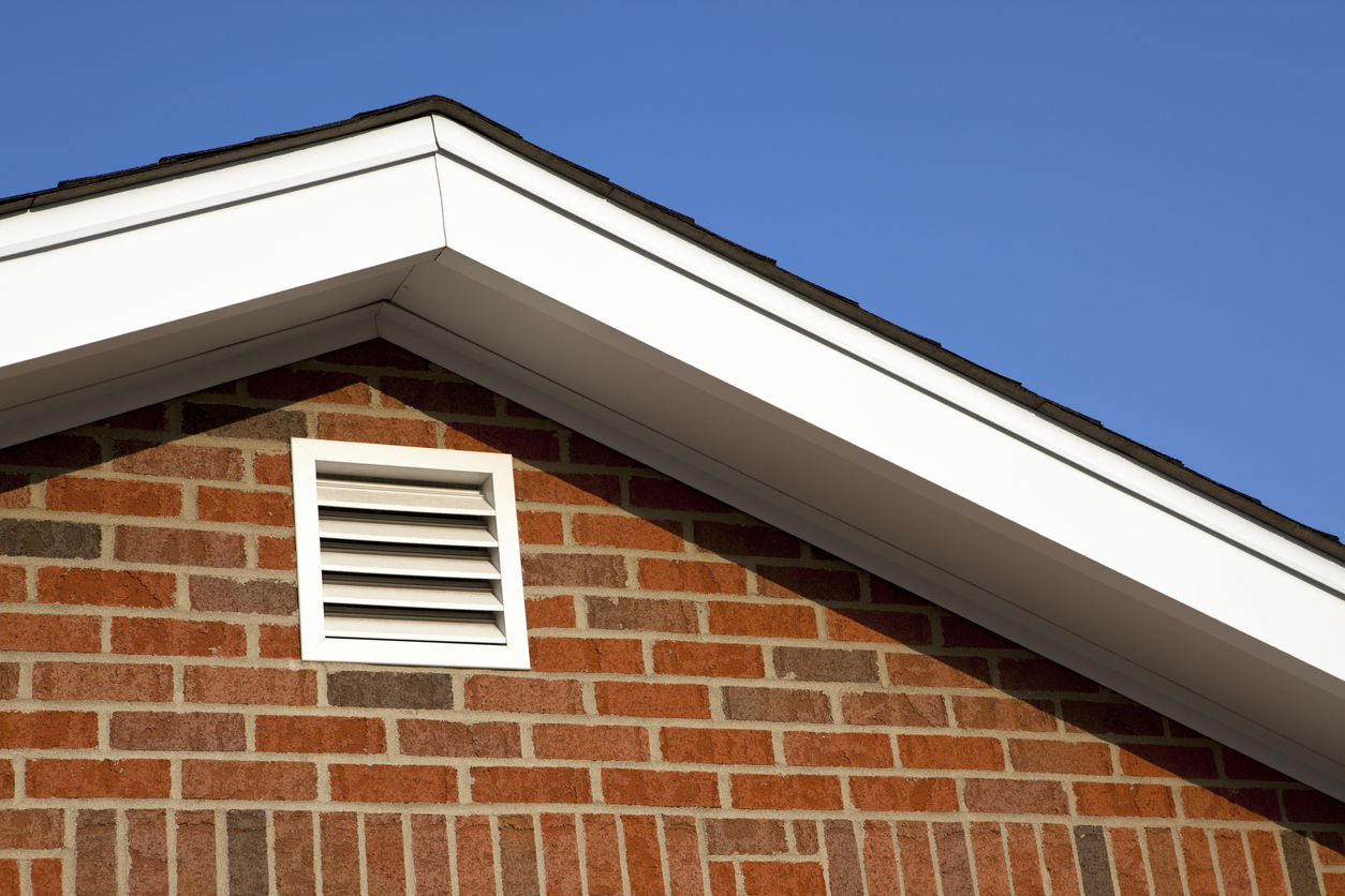 red-brick-house-with-attic-vent-near-roof-peak