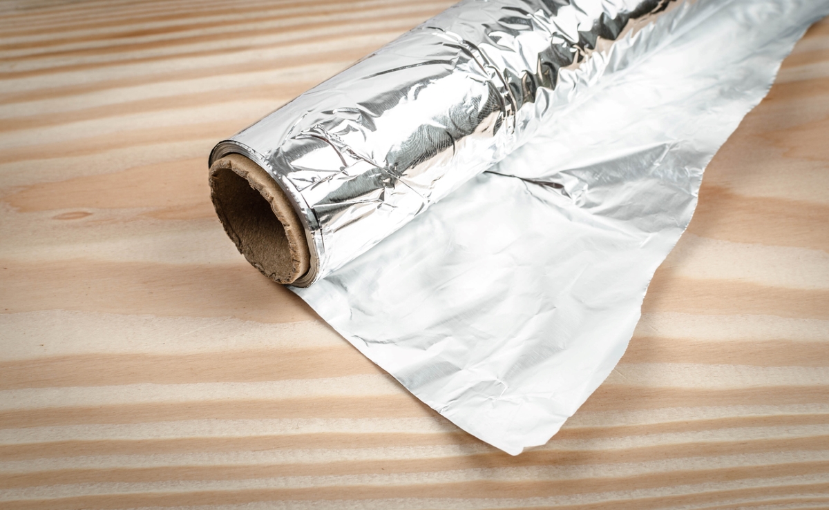 Roll of aluminum foil on table