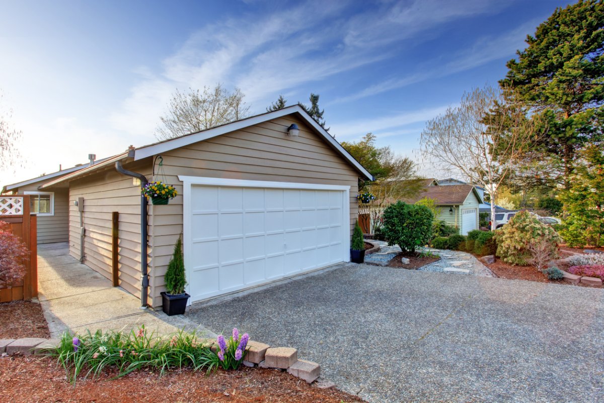 garage with gravel driveway