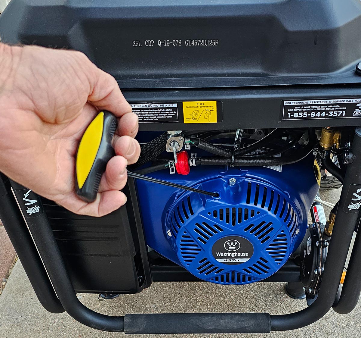 Person pulling recoil cord to start Westinghouse WGen9500DF Generator.