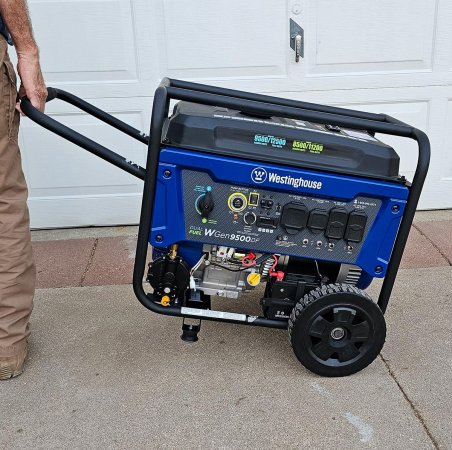 Person lifting and transporting the portable Westinghouse WGen9500DF Generator.