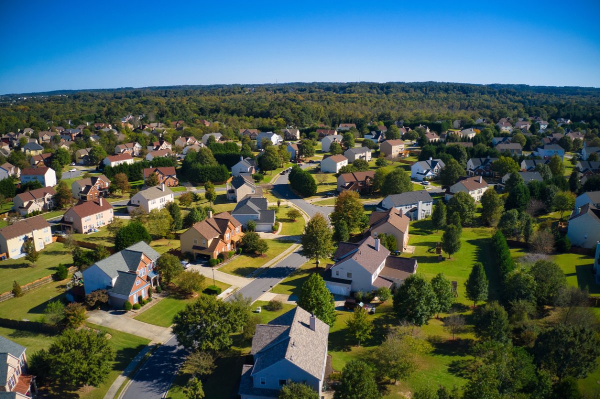 Upscale suburbs with gold course, lake, houses and roof tops