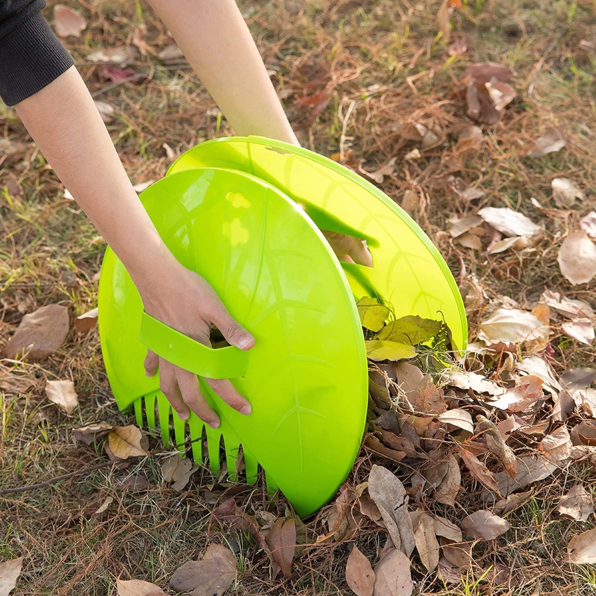 Person using leaf scoops