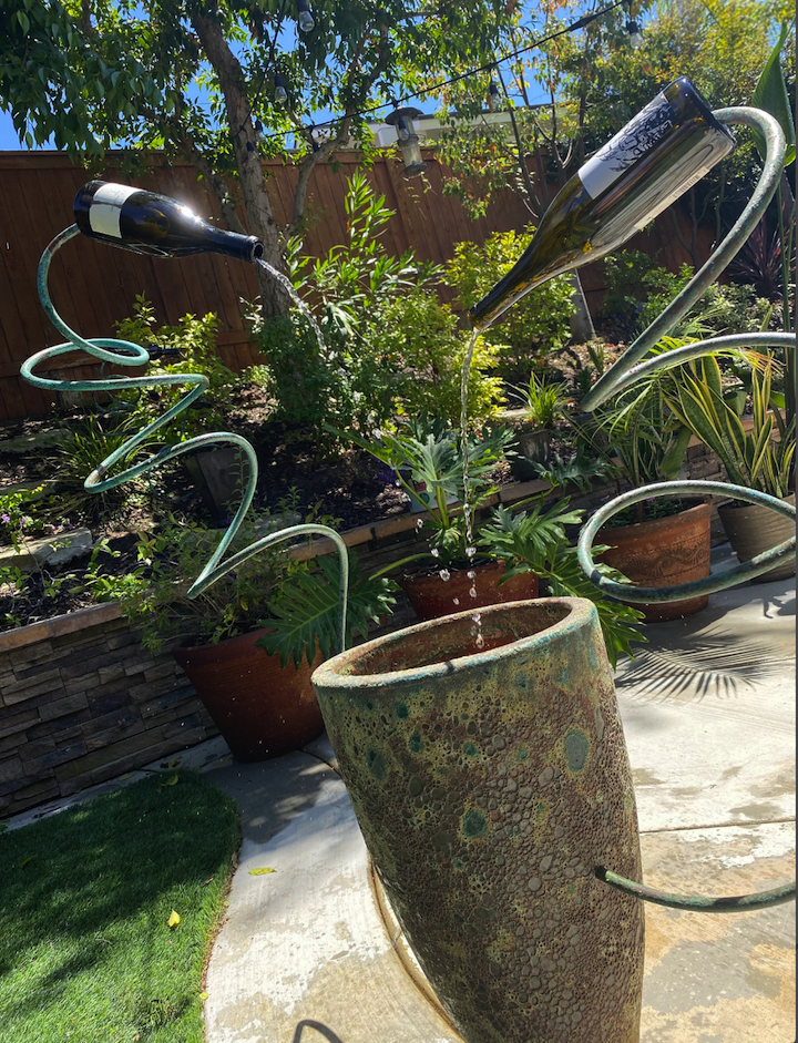 water fountain in back yard made from two wine bottles