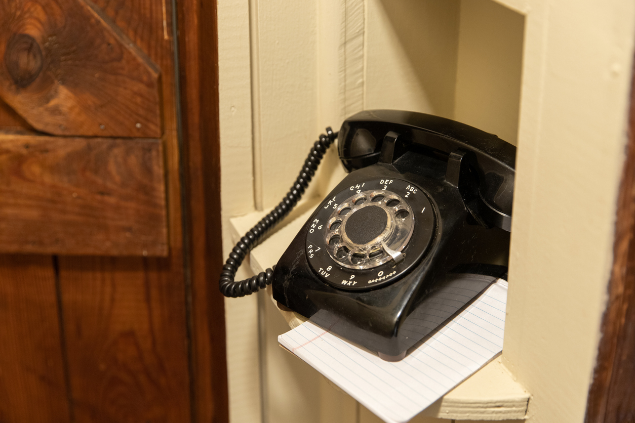 close view of black rotary phone in phone nook