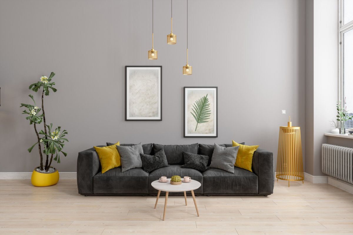 Front View Of Modern Living Room With Yellow Sconce, Gray Sofa And Yellow Pillows