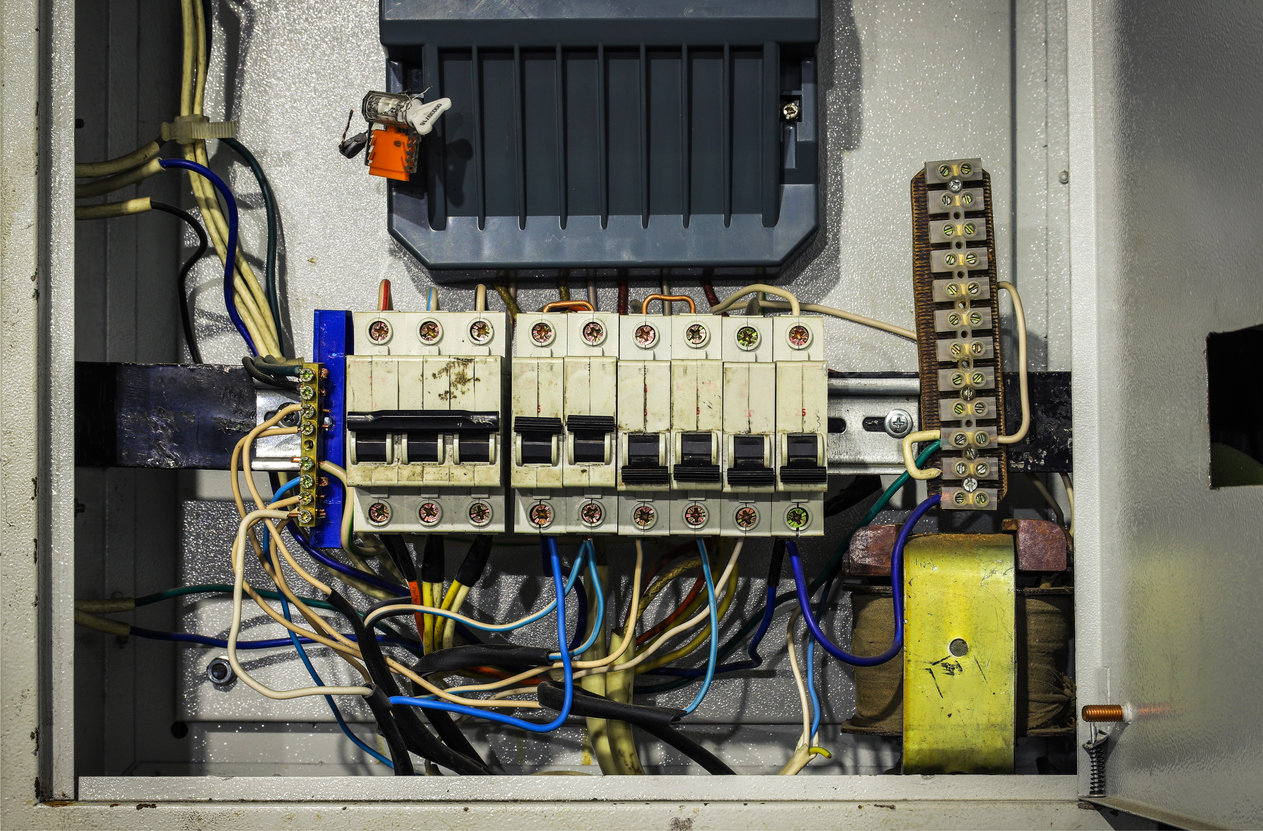 Cable chaos in electric control panel close-up. Tangled wires. Circuit breakers