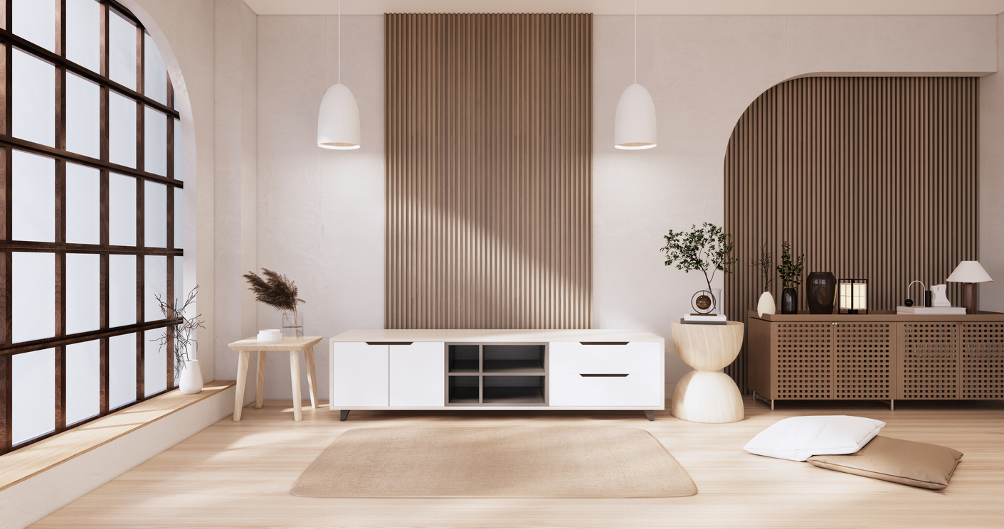 Open living space with low and long wooden cabinets next to large window.