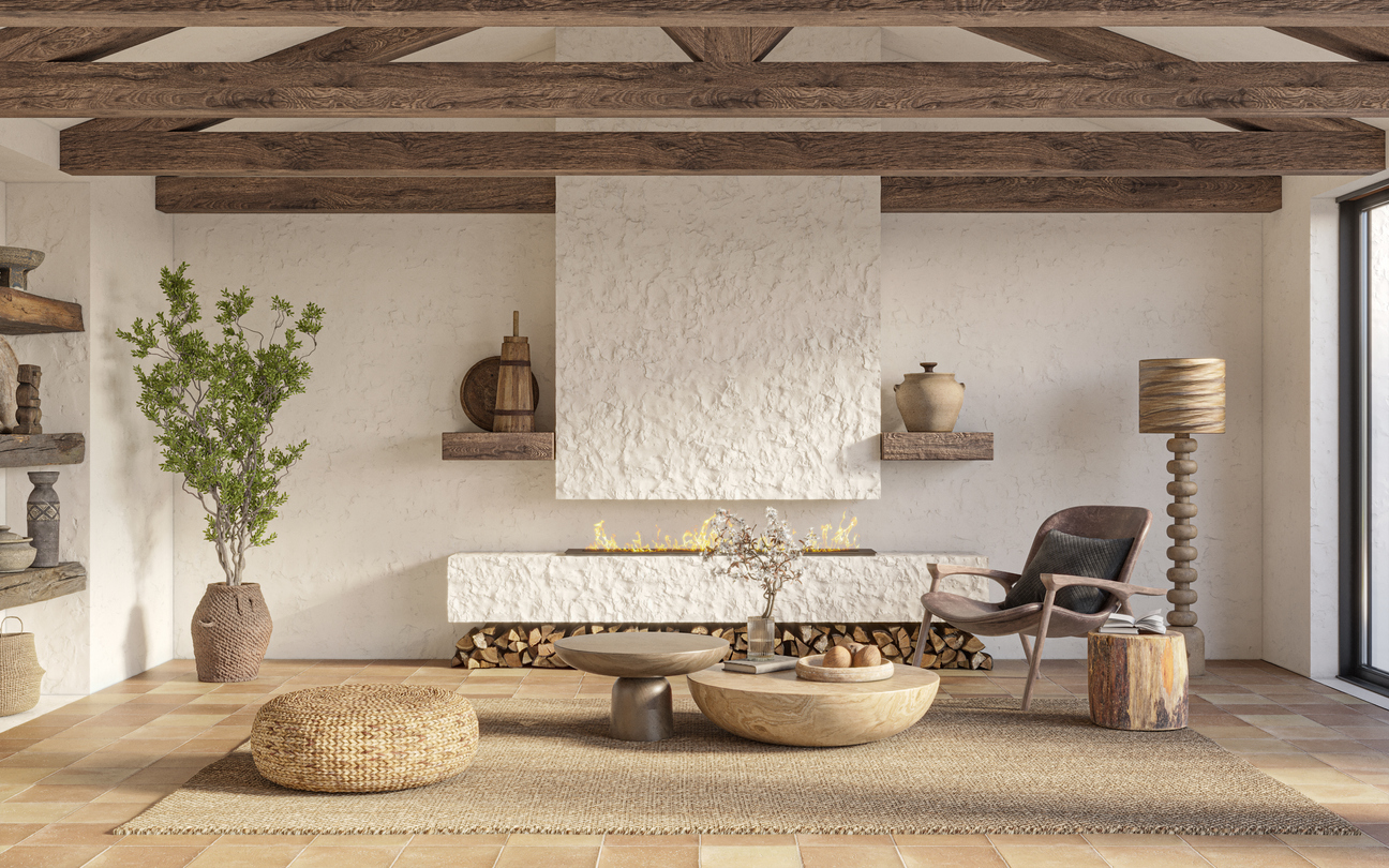 Living room with stucco walls and angled wood ceiling slats and irregular minimal furniture made from natural materials.