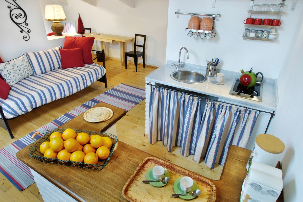 Small rustic kitchen with striped fabric.