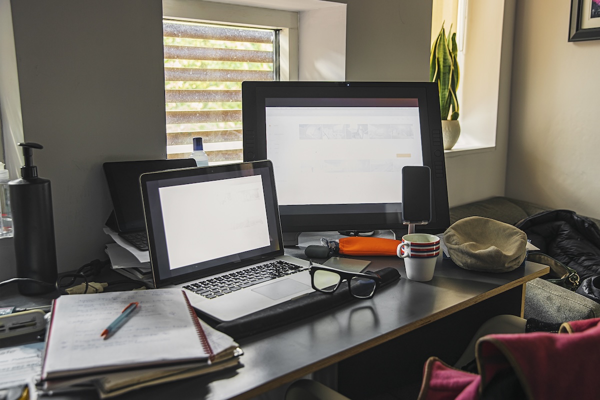 A home office setup with two computers on a desk.