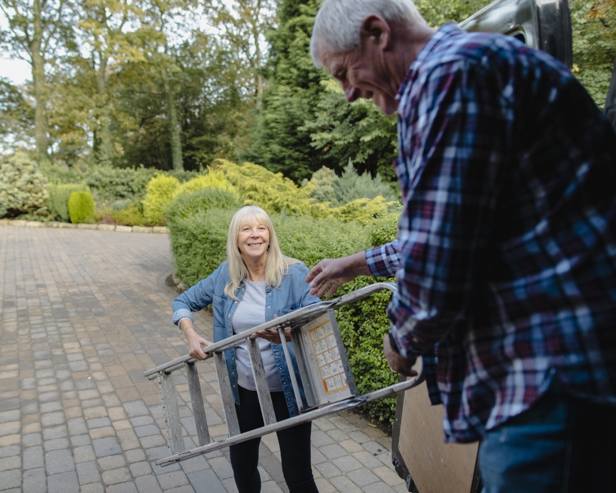 Woman sharing ladder with man.