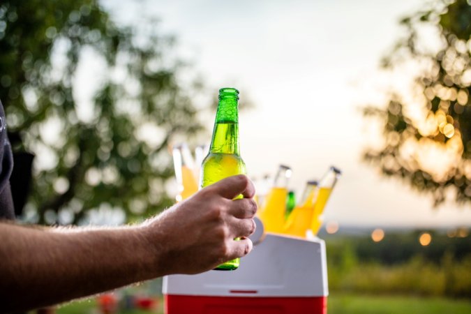 Man holding open beer bottle.