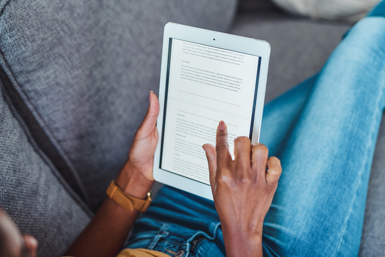 Shot of an unrecognisable woman using a digital tablet on the sofa at home