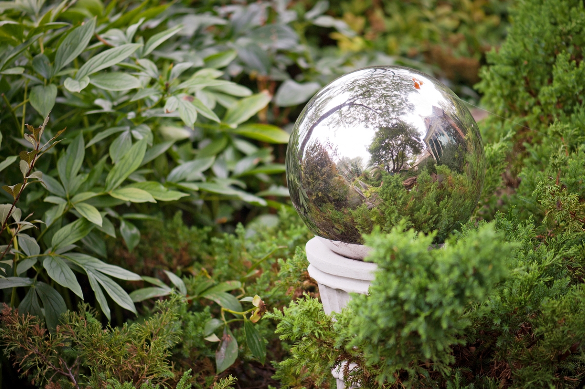 Silver gazing ball in garden.