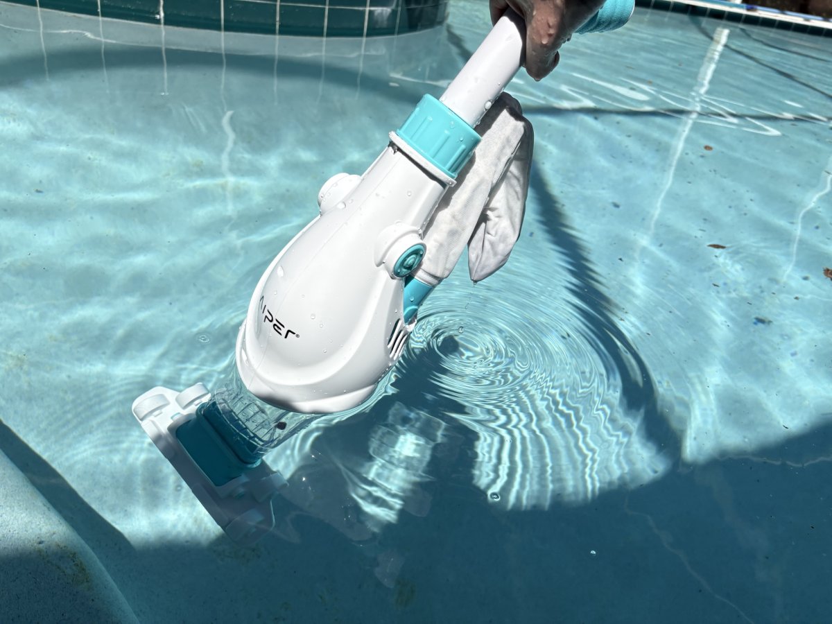 a person using Aiper Handheld Pool Vacuum