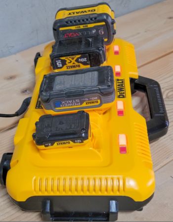 The Dewalt Charging Station with several power tool batteries plugged in for charging.