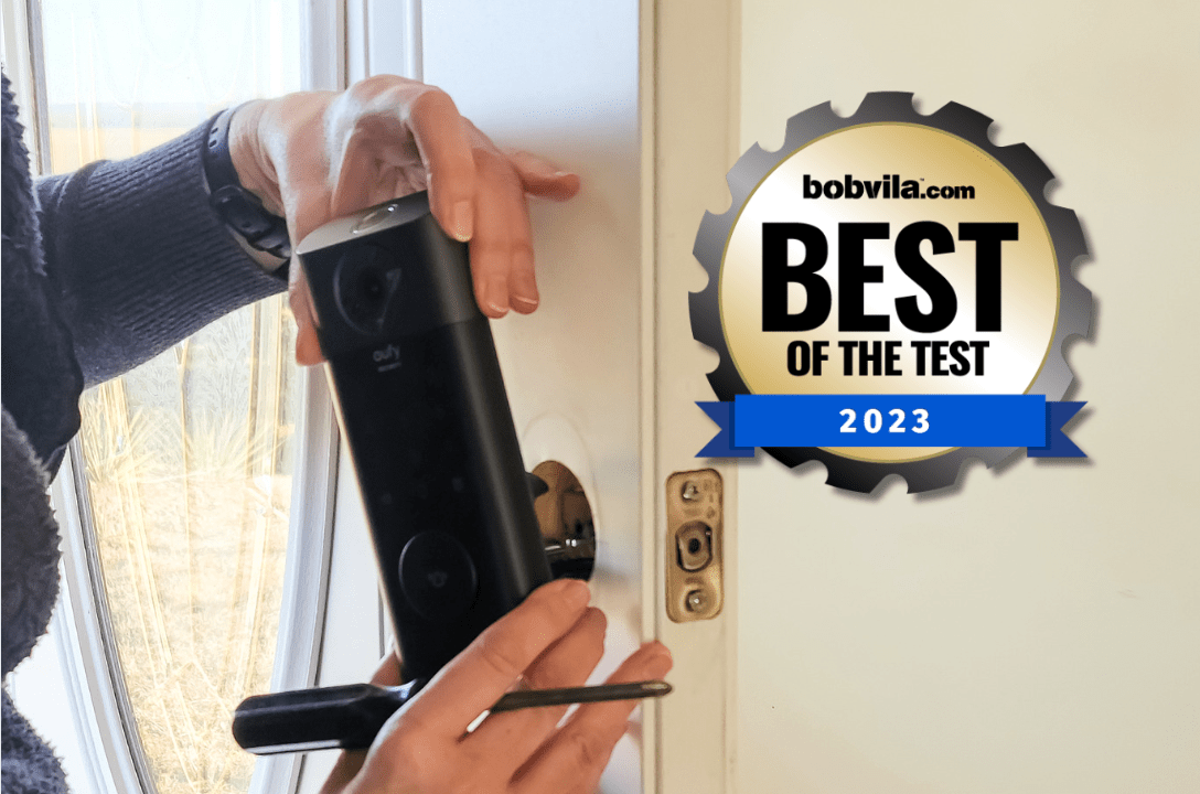 A person installing a smart lock onto a door