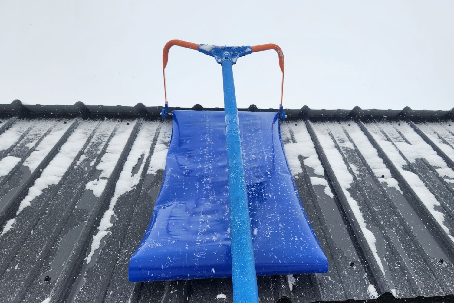 The Avalanche! Roof Rake undergoing testing pulling light snow off a metal roof.