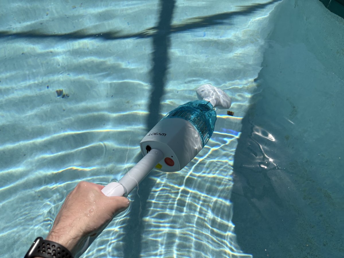 a person using Wybot Handheld Pool Vacuum