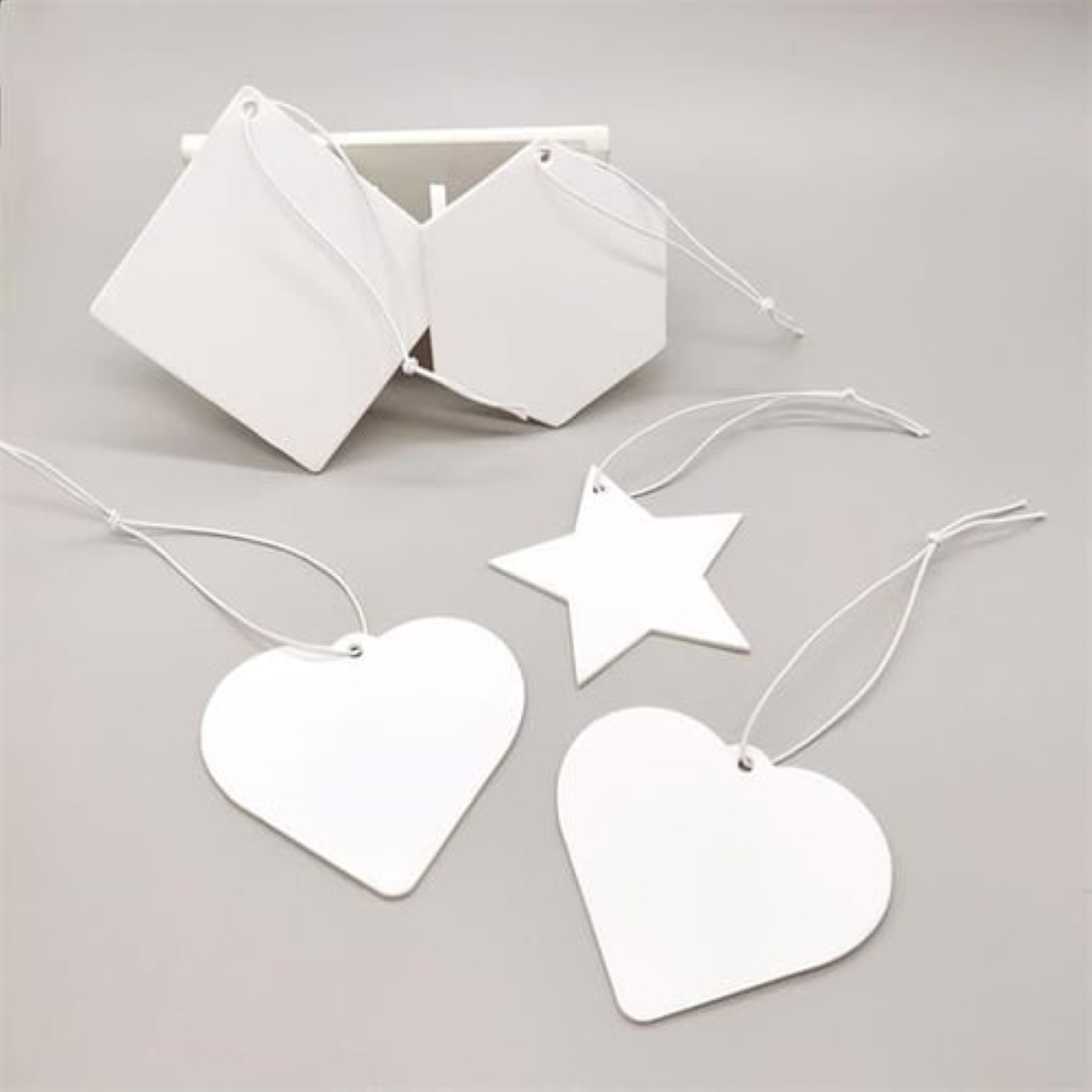 White cardboard air freshener cutouts.