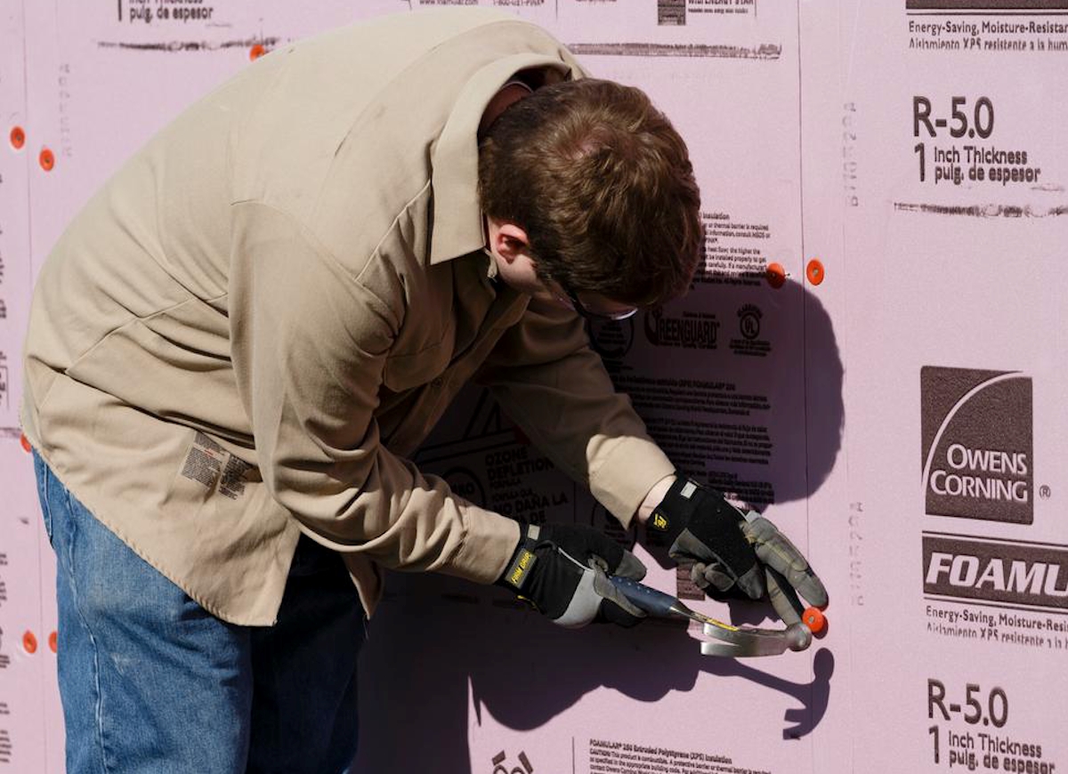 Man installing foam board.