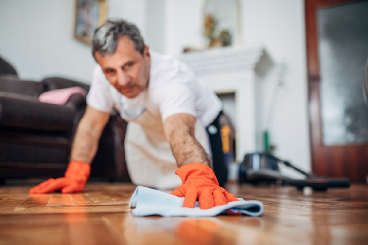 Man polishing wooden floor.